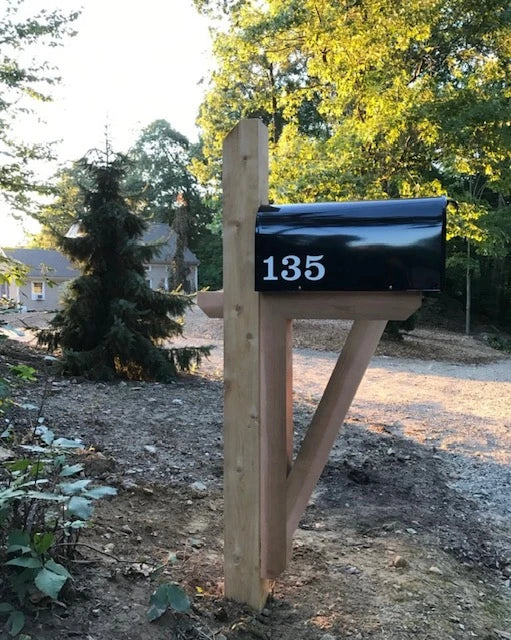 Black mailbox with house numbers mounted on a handcrafted wooden post in Roxbury, Connecticut.