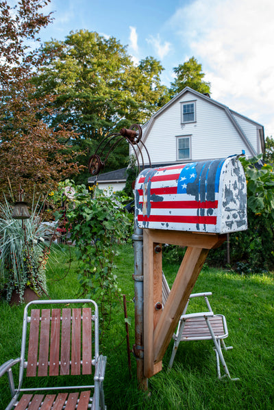Handcrafted mailbox featuring a weathered Americana-inspired finish and cedar post.