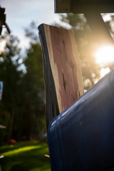 Natural cedar and charred wood materials used in handcrafted mailbox construction.
