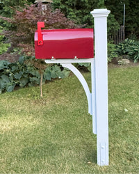 Full side view of a burgundy mailbox set featuring a white pine post, decorative post cap, and handcrafted curved cedar bracket.