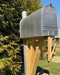 Side view of a handcrafted vintage mailbox set featuring a galvanized mailbox, red cedar architectural bracket, and durable steel mounting post.
