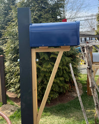 Full view of a handcrafted blue mailbox set featuring a cedar architectural bracket and durable steel core post.