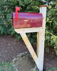 Side view of a maroon Titan vandal-proof mailbox with natural white cedar post detailing and architectural bracket support.