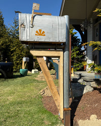 Front angle of a reclaimed silver vintage mailbox featuring industrial galvanized steel construction and natural cedar detailing.