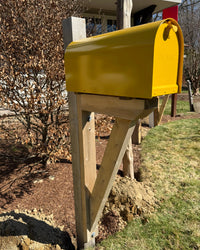 Side view of a bold yellow Titan mailbox set featuring a handcrafted cedar bracket and reinforced cedar post.