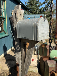 Front angled view of an extra-large vintage-style mailbox mounted on a reclaimed barn beam post with rustic cedar bracket detailing.