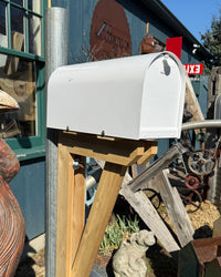 Angled front view of a white Titan mailbox paired with galvanized steel and custom cedar detailing for a clean industrial look.