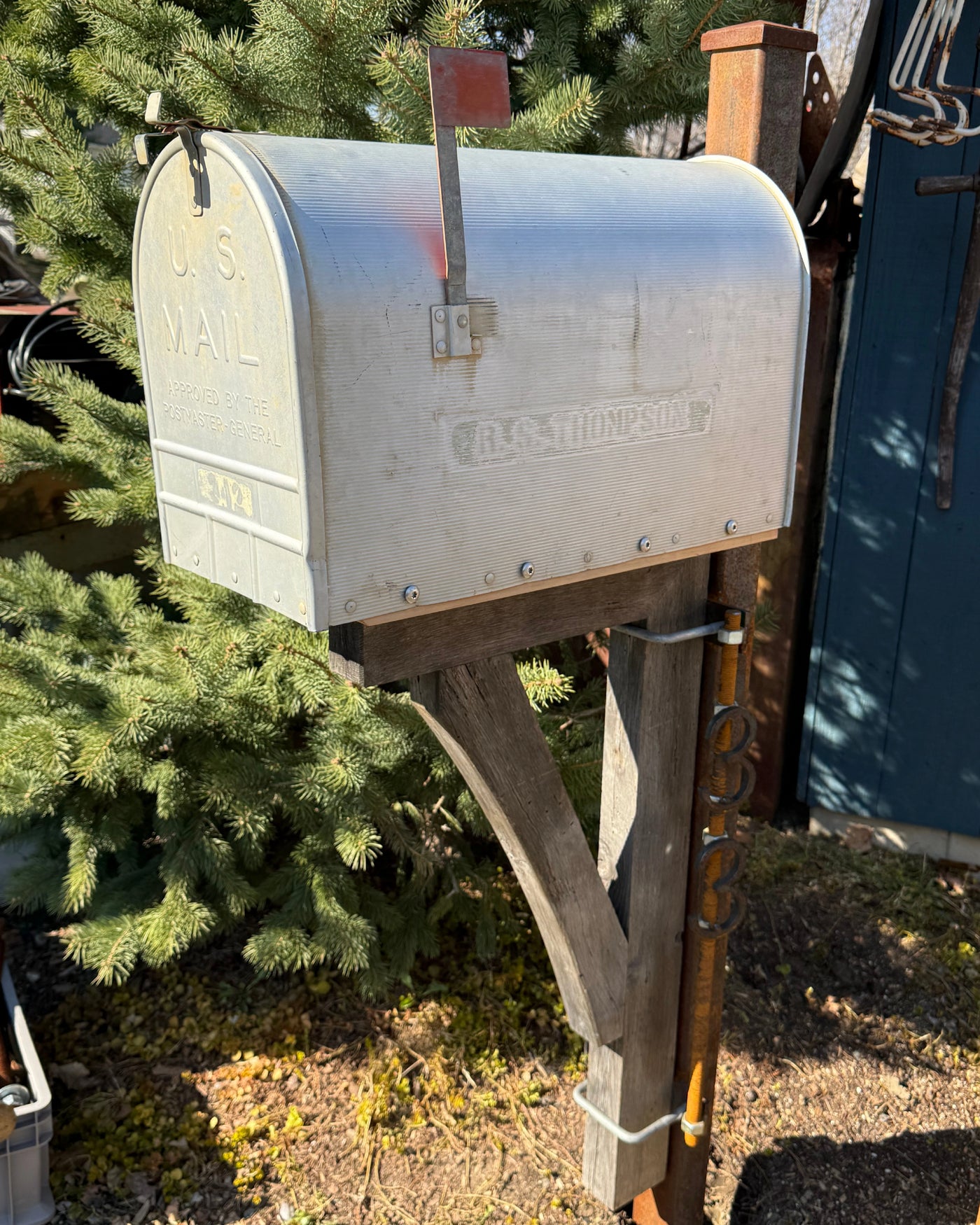 Angled front view of a vintage-inspired mailbox set featuring weathered textures, rusted steel accents, and handcrafted barn wood detailing.