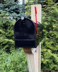 Close front angled view of a white handcrafted mailbox set featuring a galvanized steel mailbox and pressure-treated wood post.