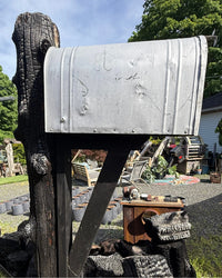 Wide side view of a bold rustic mailbox set featuring a charred cedar log post, black cedar bracket assembly, and vintage XL mailbox.