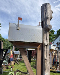 Front side view of a handcrafted mailbox set with naturally weathered cedar textures and durable rustic support construction.