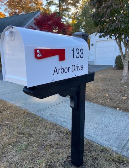 White mailbox with custom address lettering mounted on a handcrafted black post in Southport, Connecticut.