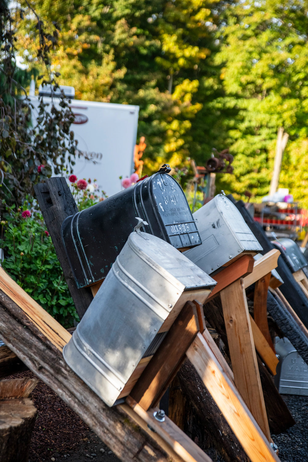 Collection of vintage mailboxes displayed outdoors as inspiration for handcrafted mailbox designs.
