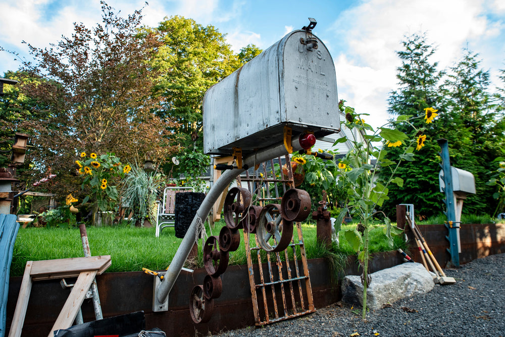 Vintage mailbox transformed into a decorative sculpture using reclaimed industrial materials.